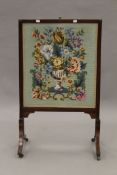 A 19th century tapestry inset sliding fire screen. 55.5 cm wide.