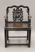 A 19th century Chinese carved hardwood open armchair. 63.5 cm wide.