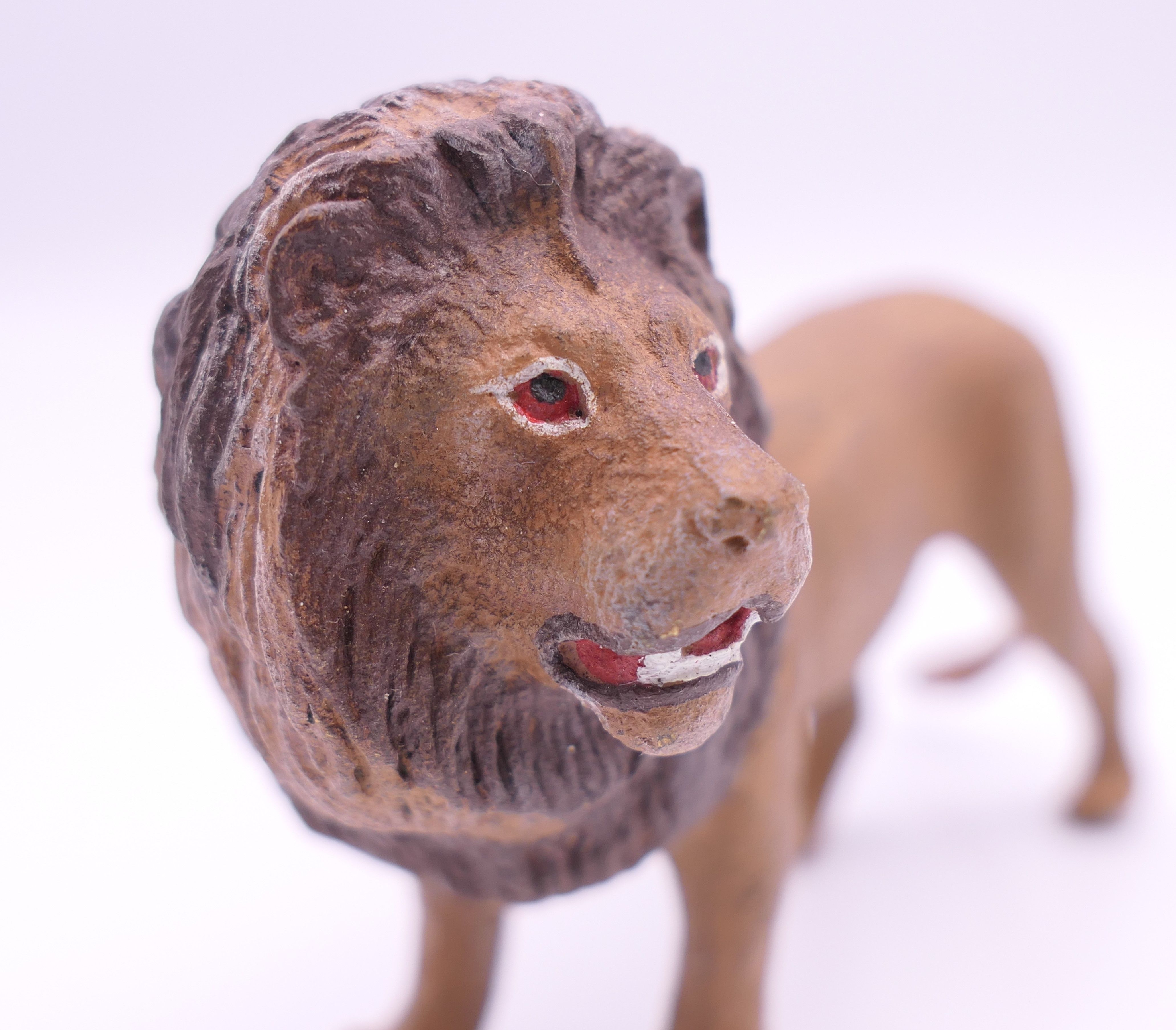 A cold painted bronze model of a lion. 9 cm long. - Image 3 of 4