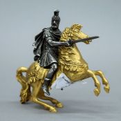 A 19th century gilt and silvered bronze model of a warrior on horseback. 11 cm high.
