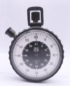 A Tag Heuer black cased stopwatch. 6 cm diameter.