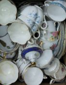 A box of various decorative porcelain tea wares.