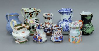 A collection of Masons Ironstone and other jugs, and a vase. The largest 18 cm high.
