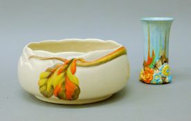 A Clarice Cliff Bizarre vase and a Clarice Cliff centre bowl. The former 15 cm high.