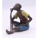 A cold painted bronze of a boy smoking a pipe. 5.5 cm high.