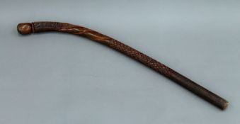 A South Seas tribal carved wooden club. 89.5 cm long.