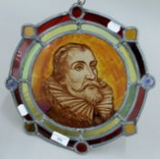 A stained lead glazed panel depicting Miguel de Cervantes. 32 cm diameter.