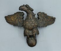 A 19th century carved oak eagle surmount. 28 cm high.