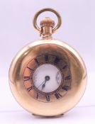 A gold plated Waltham half hunter pocket watch. 5 cm diameter.