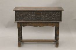 A carved oak Bible box on stand, the lid inscribed A C 1690. 91 cm long.