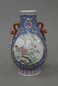 A Chinese porcelain vase with ruyi sceptre handles. 24 cm high.