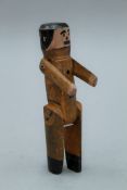 A Folk Art painted jointed wooden doll. 18.5 cm high.