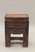 A Chinese carved hardwood nest of four tables. The largest 41 cm wide.