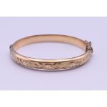 A 1/5th 9 ct rolled gold bangle form bracelet. 6.5 cm wide. 11 grammes total weight.