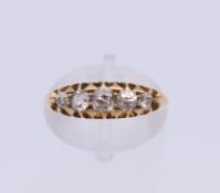 An 18 ct gold diamond five stone ring. Ring size I/J. 3.3 grammes total weight.