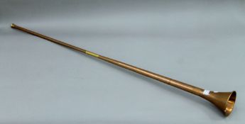 A brass and copper coaching horn. 125 cm long.