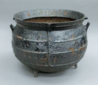 A large antique cast iron cauldron. 51 cm high.
