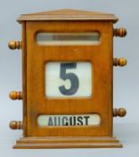 An early 20th century mahogany perpetual desk calendar. 32 cm high.