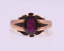 A 9 ct gold and garnet ring. Ring size O/P. 2.9 grammes total weight.