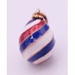 A 14 ct gold Russian enamel striped egg. 1.5 cm excluding suspension loop.