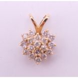 A gold diamond heart pendant. 1.25 cm high. 1.3 grammes total weight.