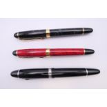 Three various fountain pens.