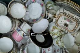 A box of decorative porcelain tea wares.