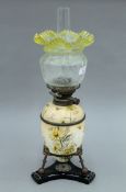 A Victorian porcelain oil lamp with etched glass shade. 59 cm high overall.