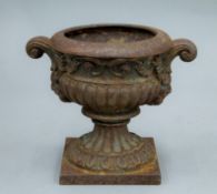 A small cast iron urn. 15.5 cm high.