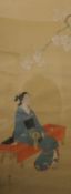 A Chinese scroll painting depicting a Female Figure Beneath Prunus Blossom, framed and glazed.