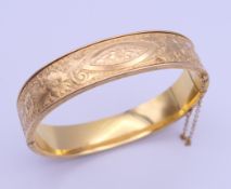 A gold plated bangle form bracelet. 6.5 cm wide.