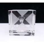 A Rolex glass paperweight. 5 cm wide.