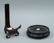 Two Chinese carved wooden stands. One 23.5 cm high, the other 17 cm diameter.
