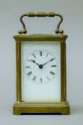 A brass cased carriage clock. 14 cm high.