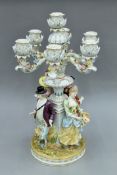 A Continental porcelain figural candelabra. 57 cm high.