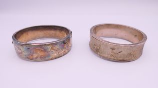 Two silver bangle formed bracelets. The largest 6.5 cm wide. 58.7 grammes.