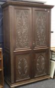 A Victorian carved oak wardrobe with fitted interior. 119 cm wide x 189 cm high.