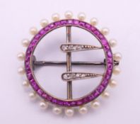 An 18 ct gold diamond, ruby and seed pearl brooch. 2.5 cm diameter. 3.7 grammes total weight.