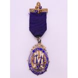 A boxed silver gilt and enamel Independent Order of Oddfellows Manchester Unity medal.
