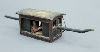 A painted wooden model of a Sedan chair. 33 cm long.