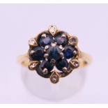 An 18 ct gold diamond and sapphire ring. Ring size O. 4.3 grammes total weight.