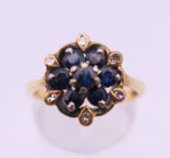 An 18 ct gold diamond and sapphire ring. Ring size O. 4.3 grammes total weight.