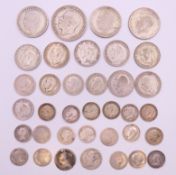 A quantity of silver and part silver coins. 128.1 grammes total weight.