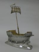 A pewter model of a boat. 35 cm long.