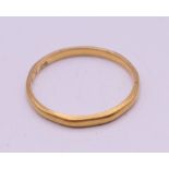 A 22 ct gold wedding band. Ring size J/K. 1.3 grammes.