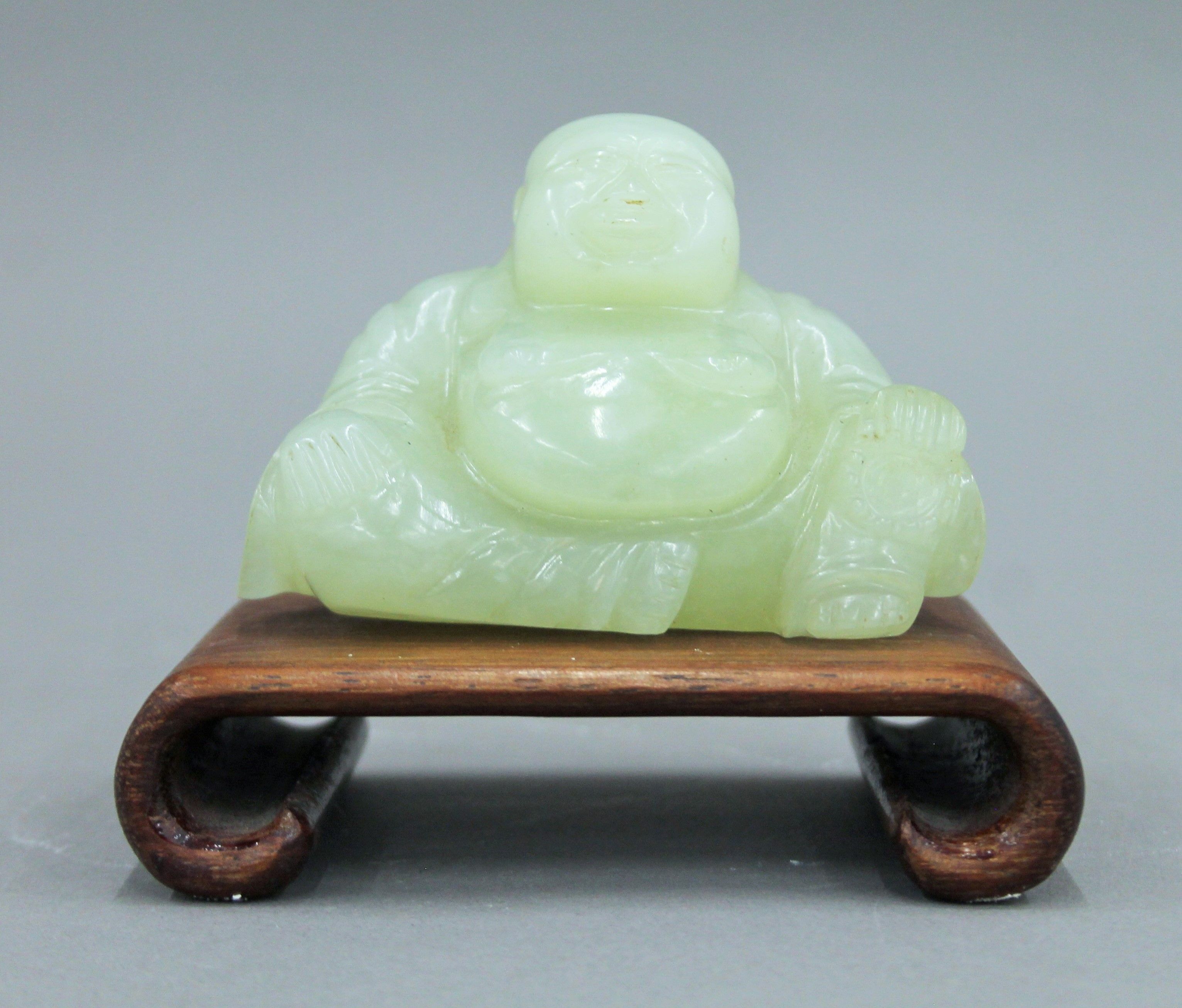 A Chinese model of Buddha on a wooden stand. 10 cm high overall. - Image 2 of 5