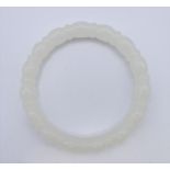 A white jade bangle. 6 cm interior diameter.