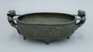 A 19th century Chinese bronze censer with twin dog-of-fo handles. 31 cm wide.