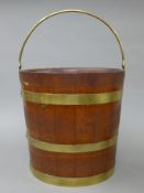 A brass bound bucket. 30 cm high excluding handle.
