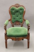 A 19th century mahogany carved open armchair. 59 cm wide.